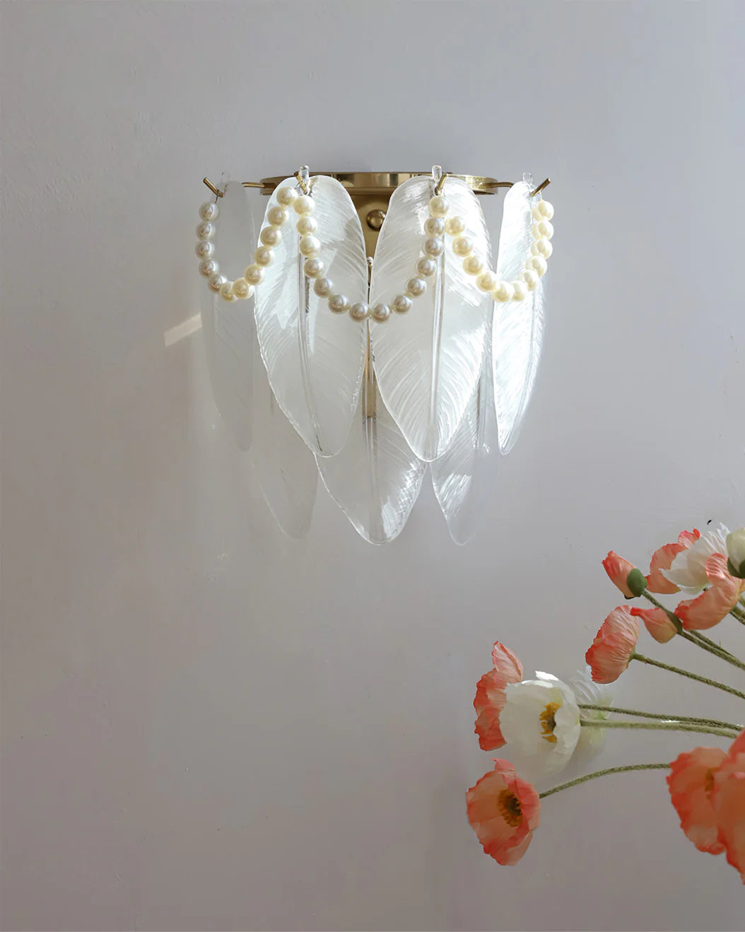 Pearl-adorned feather wall lamp—blends delicate details with a warm, inviting glow for refined aesthetics.