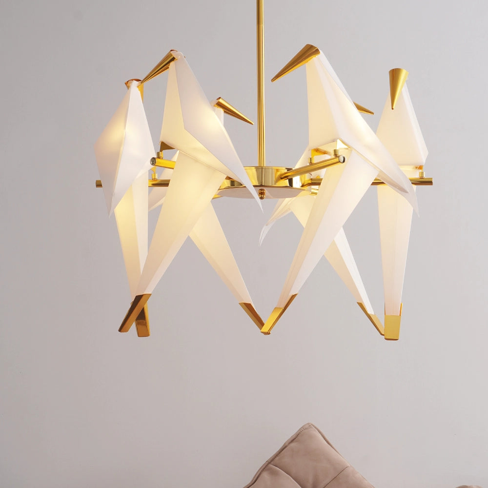 Modern chandelier with gold frame and white shades on a neutral background