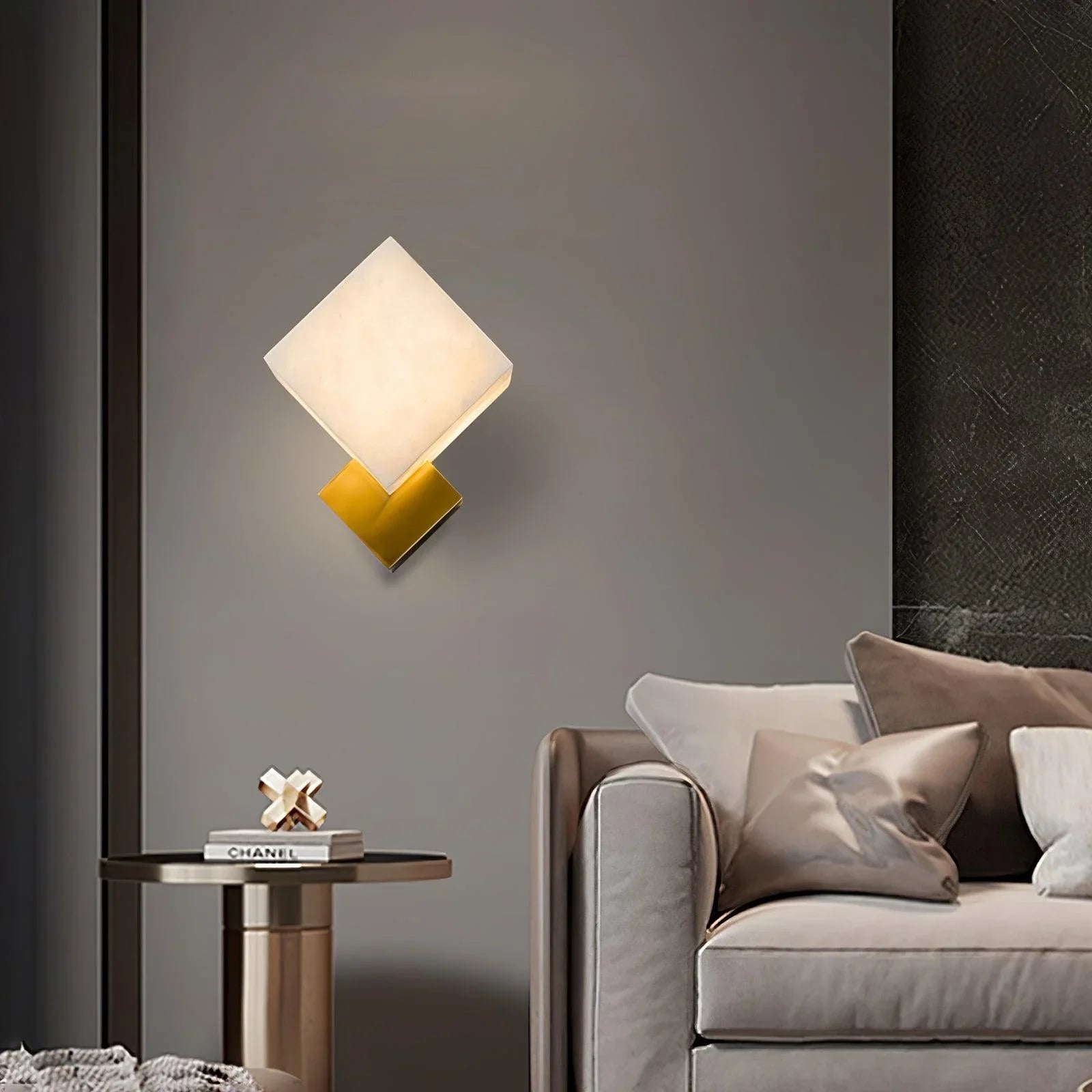 Sleek wall lamp features a cube of genuine marble, paired with a golden base for elegant lighting.