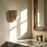 Pull‑chain design of Sienna Linen Wall Sconce brings soft warm lighting for vintage bathroom space