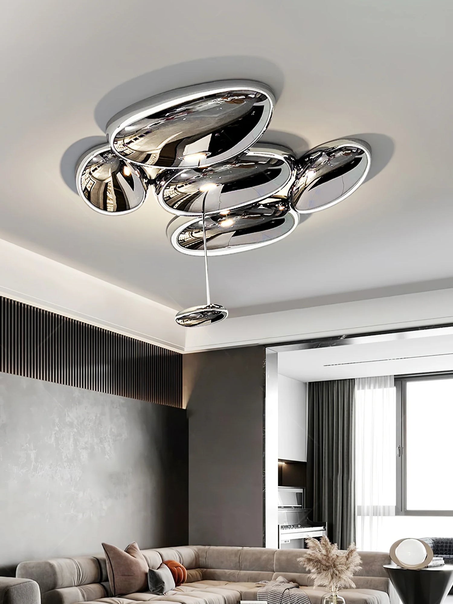 pebble cluster ceiling lamp, polished chrome pebble shape flush mount with single drop pendant, above modern fabric sofa in minimalist living room
