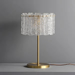 A table lamp with lots of clear crystal pieces.