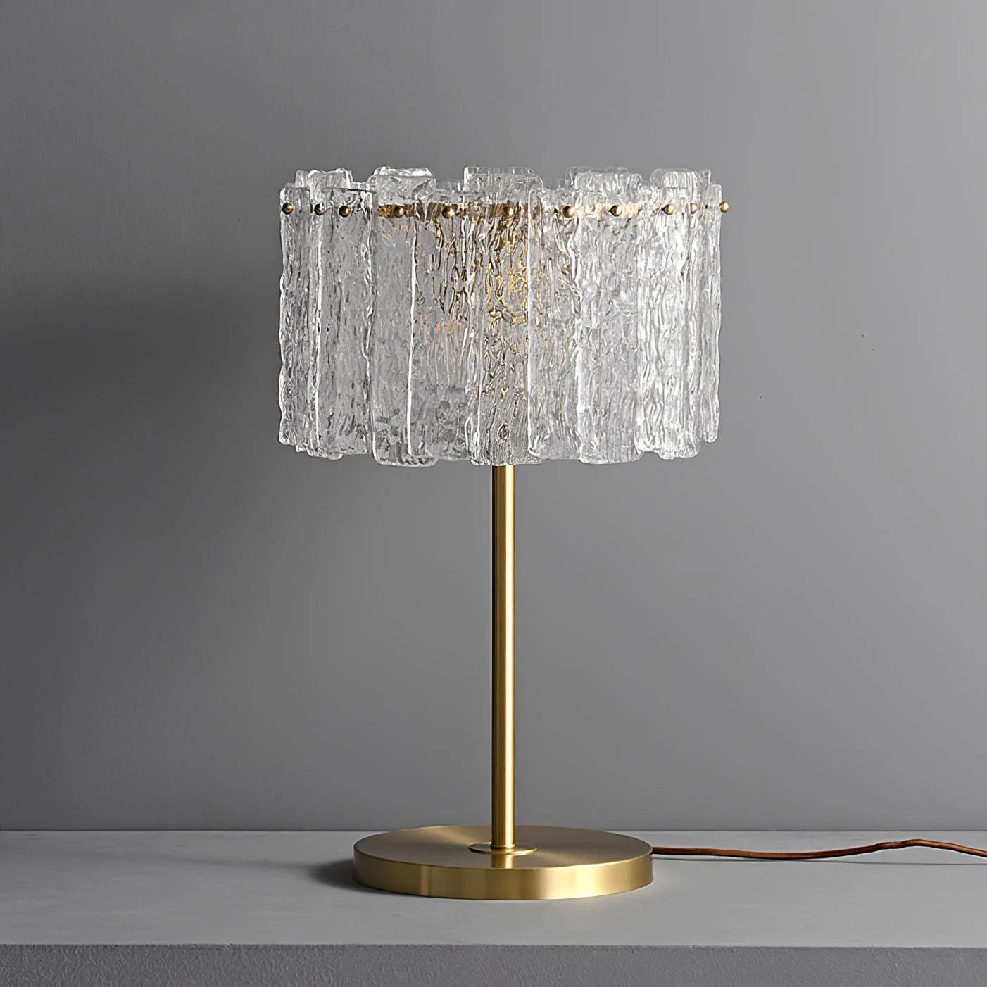 A table lamp with lots of clear crystal pieces.