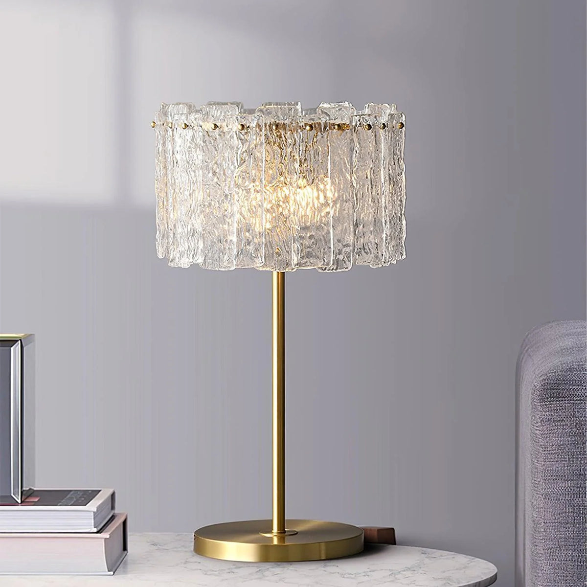 Gold and crystal table lamp illuminating a cozy living room reading corner