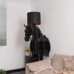 Unlit Tete Horse Floor Lamp with 3D horse-shaped frame stands in living room corner beside beige sofa