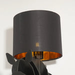 Close-up of lit Tete Horse Floor Lamp's fabric shade, highlighting warm golden inner lining and soft light diffusion