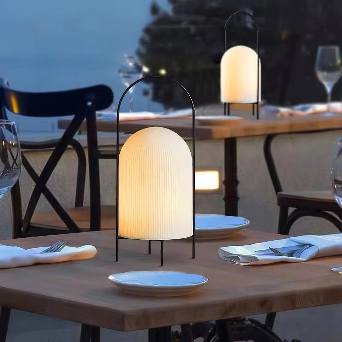 Portable ghost-themed table lamp with weather-resistant design on a patio table