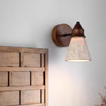 Travertine Wabi-sabi Wall Lamp: Wood-base wall light with textured travertine shade, casting soft glow beside rustic wooden decor (wabi-sabi style).