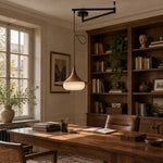 Verona Swing Arm Pendant Lamp Suspended Above Rustic Solid Wood Dining Table with Linen Tablecloth in European Apartment
