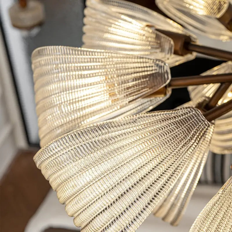 Close detail of ribbed butterfly glass lampshade, vintage butterfly glass semi flush ceiling light, transparent rippled glass with warm light shining through