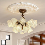 Vintage butterfly glass semi flush ceiling light, ornate white ceiling medallion, antique bronze frame, ribbed glass shades, warm home interior lighting