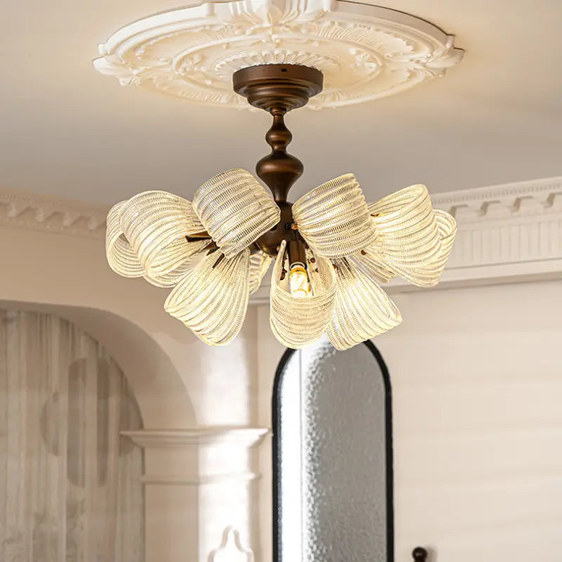Vintage butterfly glass semi flush ceiling light above dark wooden bed, cream wall with decorative wall frames, classic bedroom interior