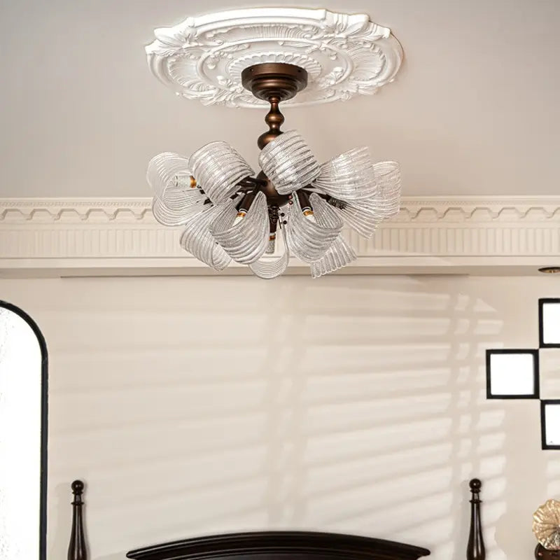 Close detail of ribbed butterfly glass lampshade, vintage semi flush ceiling light, transparent rippled glass with warm light shining through