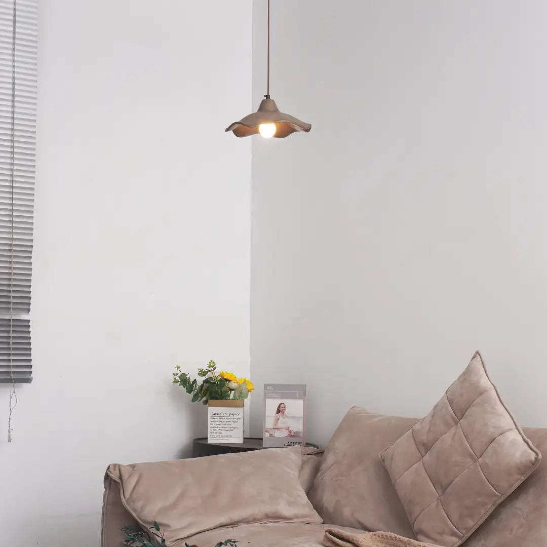 Wavy Cement Pendant Light illuminating a cozy living space with neutral tones and soft textures.