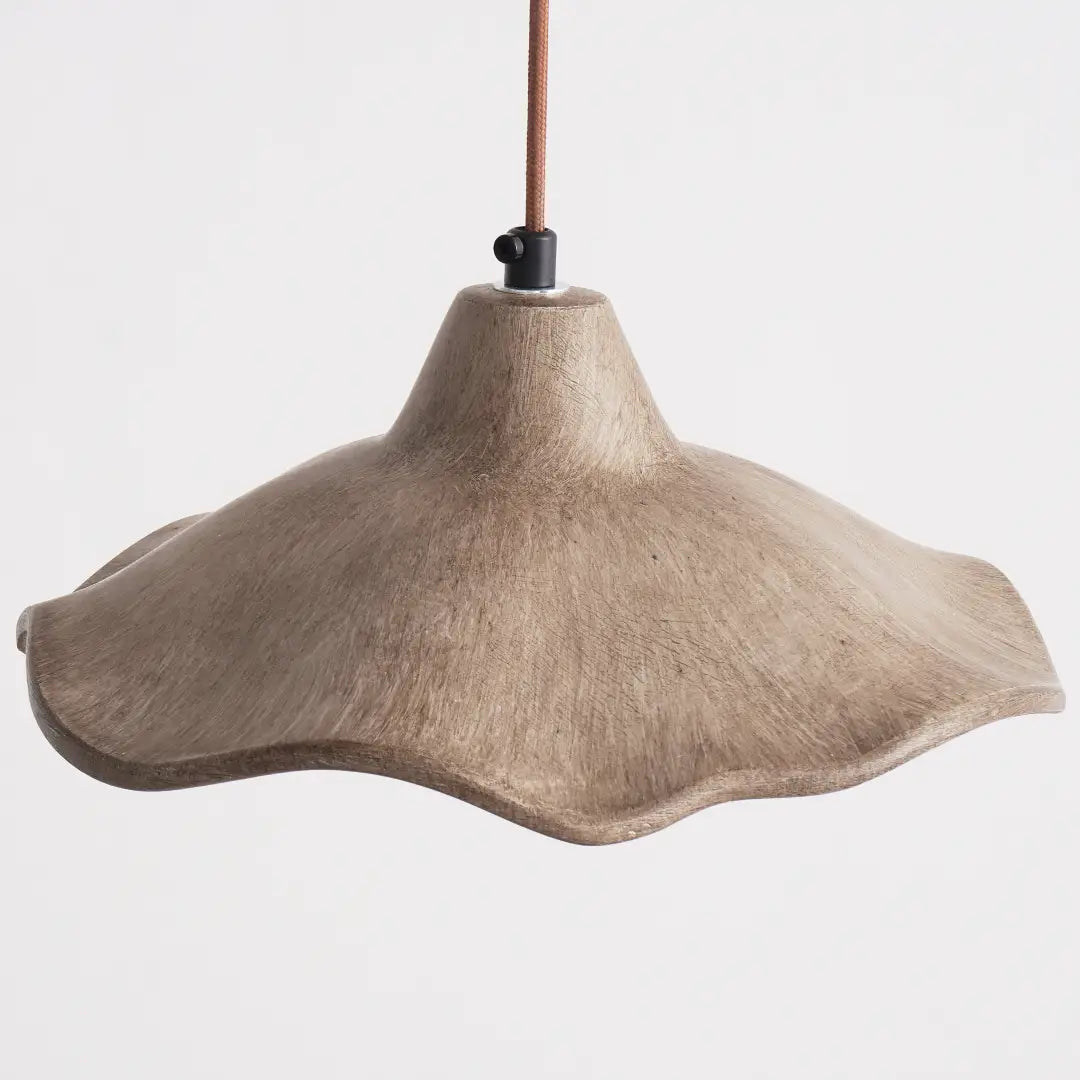 intricate edge carving and raw cement texture define the craft charm of wavy cement pendant light