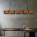 The rustic vintage wood pendant light provides lighting for the simple table