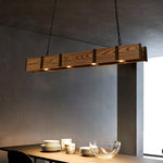 The pendant light made of long strips of wood hangs on the cleaning table