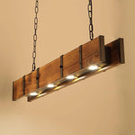 The four spotlight sources of the long wooden pendant light emit warm light.