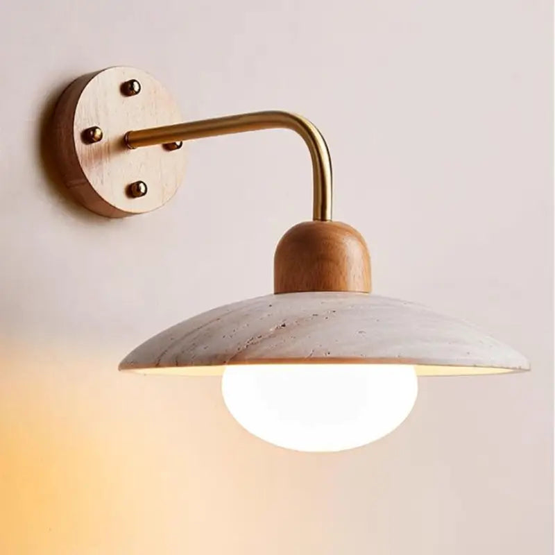 Zanara Travertine Wall Lamp featuring metal, wood, and travertine materials with a warm, gentle glow.