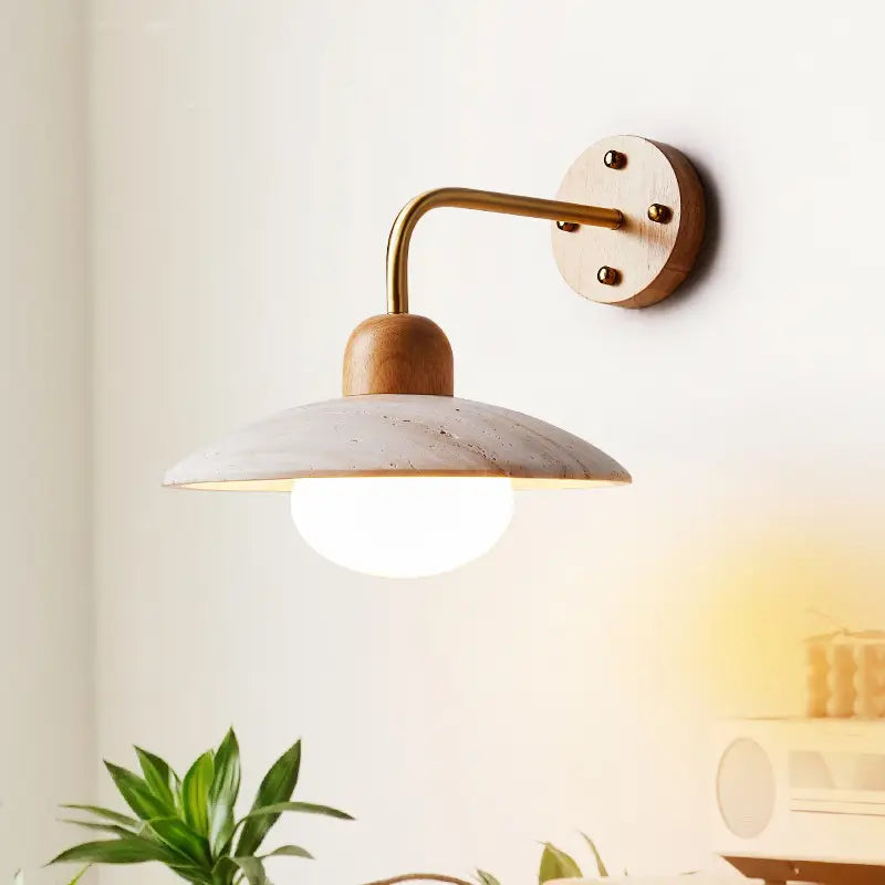 Zanara Travertine Wall Lamp with a sleek metal and wood design, illuminating a cozy living space with gentle light.