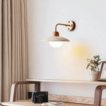 Zanara Travertine Wall Lamp illuminating a cozy workspace with wooden accents and soft lighting.